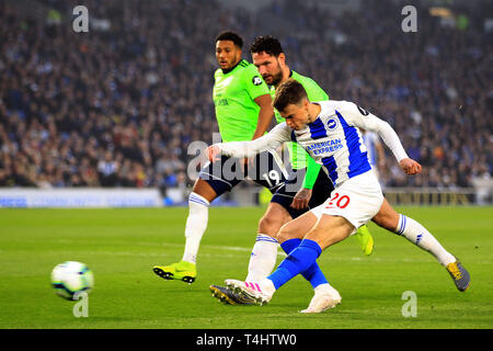 Brighton, UK. 16th Apr, 2019. Solly March of Brighton & Hove Albion (R) takes a shot at goal. Premier League match, Brighton & Hove Albion v Cardiff City at the Amex Stadium in Brighton on Tuesday 16th April 2019. this image may only be used for Editorial purposes. Editorial use only, license required for commercial use. No use in betting, games or a single club/league/player publications. pic by Steffan Bowen/Andrew Orchard sports photography/Alamy Live news Credit: Andrew Orchard sports photography/Alamy Live News Stock Photo