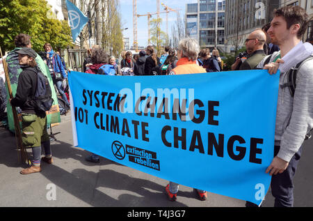 Berlin, Germany. 17th Apr, 2019. People take part in the campaign 'Get out of the animal industry - agricultural change for climate justice now' of the movement 'Extinction Rebellion Germany' in front of the seat of the German Farmers' Association. The movement 'Extinction Rebellion Germany' wants to make between 15th and 27th April several actions of civil disobedience against climate crisis. Credit: Wolfgang Kumm/dpa/Alamy Live News Stock Photo