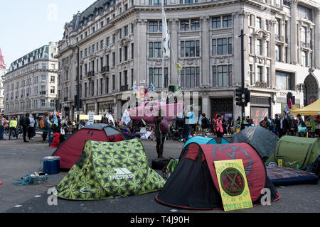 London, UK. 17th Apr, 2019. The Extinction Rebellion boat and tents in Oxford Circus during the Extinction Rebellion strike in London.Extinction Rebellion protesters have blocked five central London landmarks to protest against the government inaction on climate change. Credit: Brais G. Rouco/SOPA Images/ZUMA Wire/Alamy Live News Stock Photo