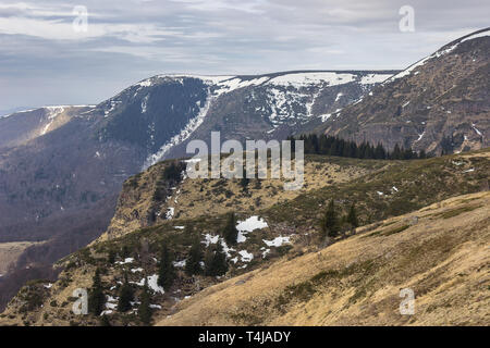 Amazing, rocky, alien highlands of juniper covered Old mountain and transition from winter to spring season Stock Photo