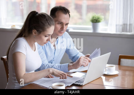 Millennial couple studying contract for new house before signing Stock Photo