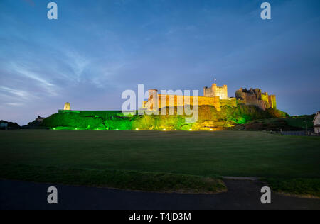 Bamburgh castle floodlit at night - Northumberland, England, UK Stock Photo