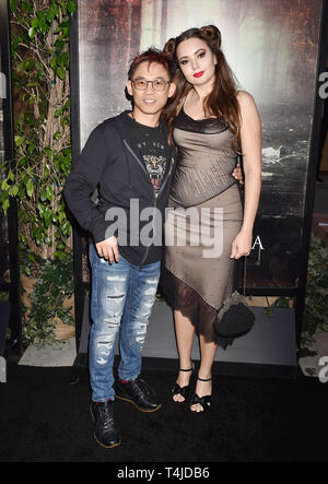 HOLLYWOOD, CA - APRIL 15: James Wan (L) and Ingrid Bisu arrive at the premiere of Warner Bros' 'The Curse Of La Llorona' at the Egyptian Theatre on April 15, 2019 in Hollywood, California. Stock Photo