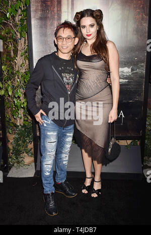 HOLLYWOOD, CA - APRIL 15: James Wan (L) and Ingrid Bisu arrive at the premiere of Warner Bros' 'The Curse Of La Llorona' at the Egyptian Theatre on April 15, 2019 in Hollywood, California. Stock Photo