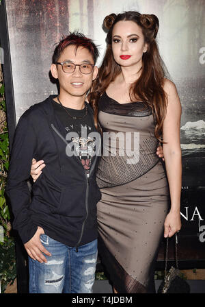 HOLLYWOOD, CA - APRIL 15: James Wan (L) and Ingrid Bisu arrive at the premiere of Warner Bros' 'The Curse Of La Llorona' at the Egyptian Theatre on April 15, 2019 in Hollywood, California. Stock Photo