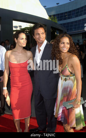 LOS ANGELES, CA. July 19, 2004: Actress HALLE BERRY (right) with actor BENJAMIN BRATT & wife actress TALISA SOTO at the world premiere, in Hollywood, of their new movie Catwoman. Stock Photo