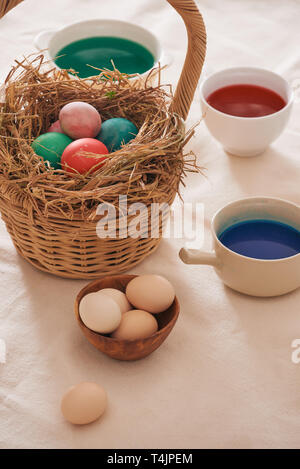 Beautiful Easter composition with multicolored eggs and flowers on linen background Stock Photo