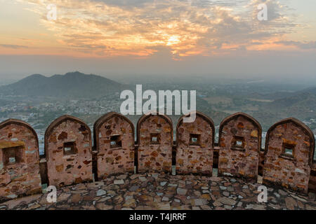 Ancient long wall with towers around Amber Fort and view of Amber village at morning. Jaipur. Rajasthan. India Stock Photo