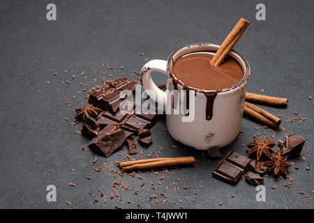Cup of hot chocolate and pieces of chocolat on dark concrete background Stock Photo