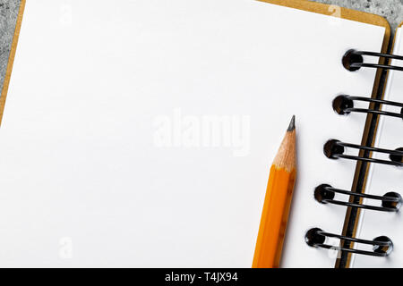 Graphite pencil on notepad with copy space, top view Stock Photo