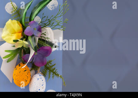 Happy Easter. Congratulatory easter background. Easter eggs and flowers. Copy space Stock Photo