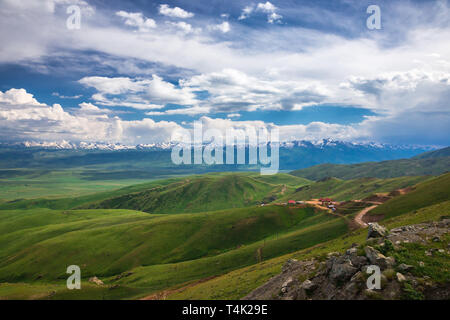 View of the mountains in the clouds from the pass. Mountain landscape. Kyrgyzstan. Suusamyr Valley. Stock Photo