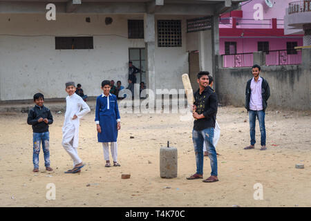 Amber village, India - January 30, 2019: Indian young boys playing cricket on the street of Amer. Rajasthan Stock Photo