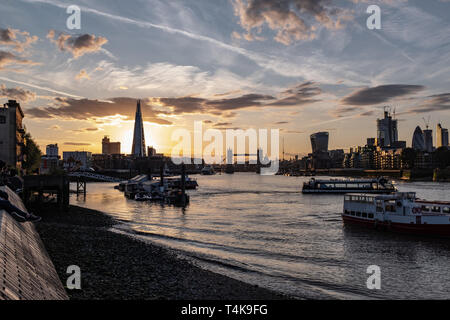 Beautiful sunset from the south bank of the river Thames and looking west towards the famous skyscrapers of the city and central London, and the iconi Stock Photo