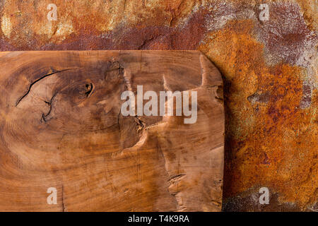 Vintage cutting board on rusty metal background, view from above Stock Photo