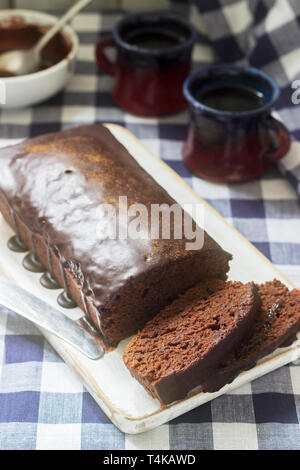 Vegan Mexican chocolate cake with chili, cinnamon and chocolate icing served with coffee. Selective focus. Stock Photo