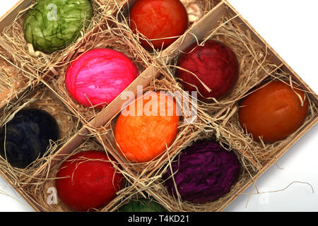 Colourfully painted Easter eggs in a wooden box with straw Stock Photo