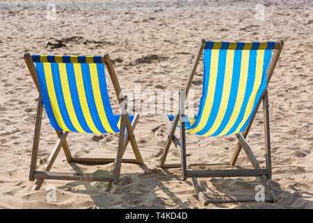 Two empty deckchairs ready for hire on beach at Bournemouth, Dorset UK in April Stock Photo