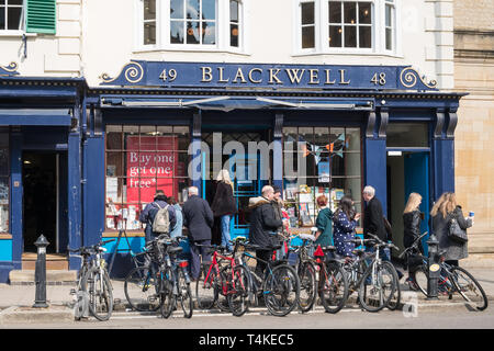Bicycles parked in the road outside Blackwell Bookshop in Broad Street, Oxford, UK Stock Photo