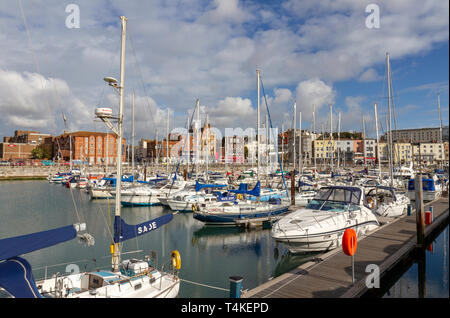 View across boats moored in the Inner Marina of the Royal Harbour Marina in Ramsgate, Kent, UK. Stock Photo