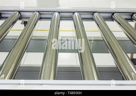 The conveyor chain, and conveyor belt on production line set up in clean room area. Stock Photo