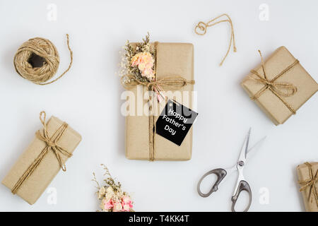 Father's day concept. DIY hand mand Fathers Day gifts with tag Happy Father's Day with beautiful natural flower bouquet on white background. Greetings Stock Photo