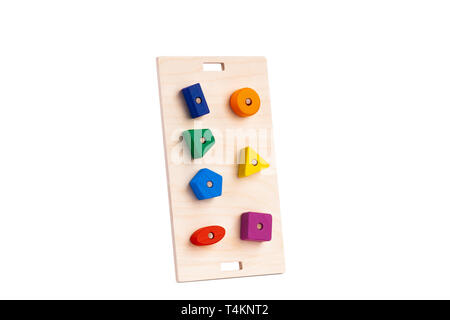 Photo of a wooden toy  children's sorter with small wooden details in the form of geometric shapes (rectangle, square, circle, triangle), in different Stock Photo