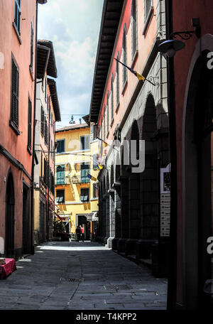 View along Via Fulvio Testi, and the columns of the market place, Castelnuovo di Garfagnana, Tuscany Stock Photo