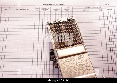 vintage adding machine on ledger purchases journal page Stock Photo
