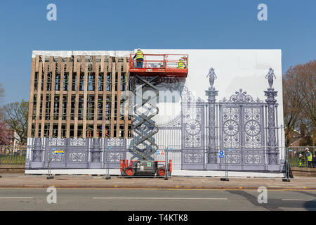 17 April 2019 - Warrington Town Hall Golden Gates have been removed for restoration and a large impression left in their place. Workmen using a Skyjac Stock Photo
