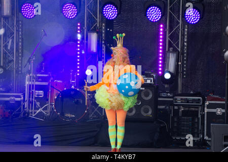 Girl in black top hat and clown makeup circus acts on stage . Russia Berezniki 26 may 2019 Stock Photo