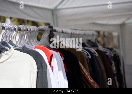 Winter clothes hanged on a clothes rack Stock Photo