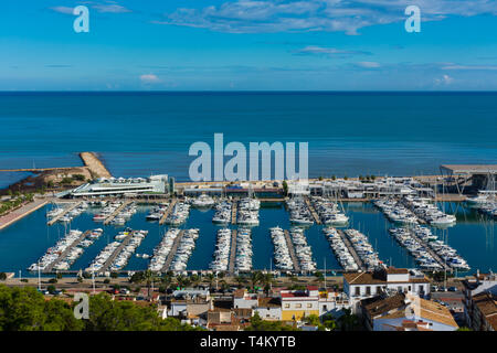 Denia, Alicante, Spain, november 21, 2018: Sailboats in the marina, ferry station and promenade next to the old town captured from the castle Stock Photo