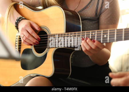 Female hands holding and playing western Stock Photo