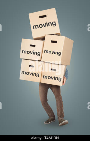 A man is carrying many moving boxes - isolated on a neutral background Stock Photo