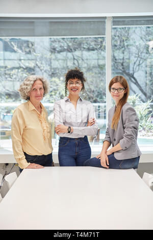 Three successful businesswomen in the office as a women quota concept Stock Photo