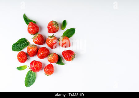 Fresh berries on white background, top view. Strawberry and mint leaf, flat lay. Summer background Stock Photo