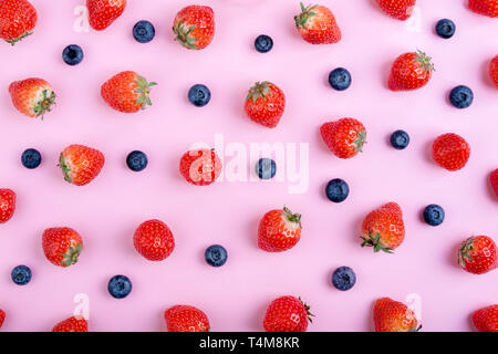 Strawberry and blueberry on pastel pink background, top view. Berries pattern, flat lay. Strawberry and blueberry isolated on pink background. Creativ Stock Photo