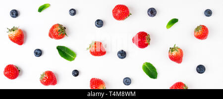 Strawberry, blueberry, mint leaves isolated on white background. Berries pattern, flat lay. Creative food concept. Long web format Stock Photo