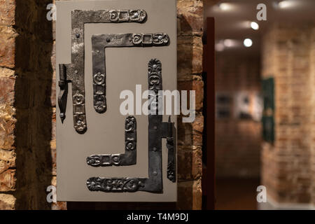Old door holes and handles - Wooden entrance on brick walls - Handles made of metal Stock Photo