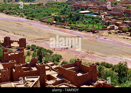Aït Benhaddou village is divided in two parts. The modern part is filled with tourist shops and parking spaces. Upon crossing the Oued (dry riverbed), Stock Photo