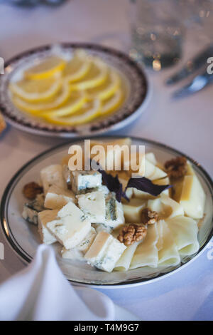 Cheese platter with different cheeses, served with grapes, figs, nuts and honey Stock Photo