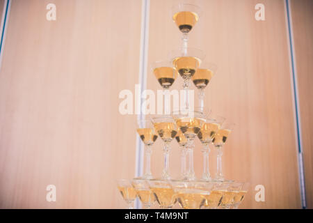 Champagne glasses standing in a tower at the party. Stock Photo