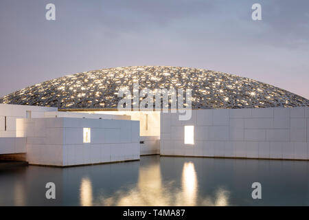 SAADIYAT ISLAND, ABU DHABI, UNITED ARAB EMIRATES - April 2, 2019: The Louvre Abu Dhabi on Saadiyat Island, designed by architect Jean Nouvel.  ( Ryan  Stock Photo