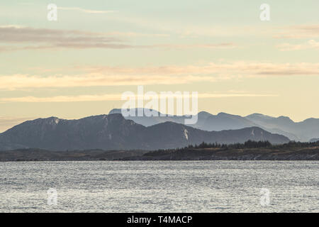 Sunrise over the mountains from a Norwegian fjord near Trondheim. Stock Photo