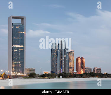 ABU DHABI, UNITED ARAB EMIRATES - April 5, 2019: Abu Dhabi National Oil Company / ADNOC head office (left), Etihad Towers (centre), which consist of r Stock Photo