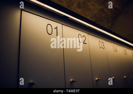 Row of metal doors of the vault safe locker in the locker room or archive box. Stock Photo