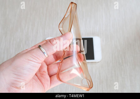 Silicone case for smartphone bent in his hand Stock Photo