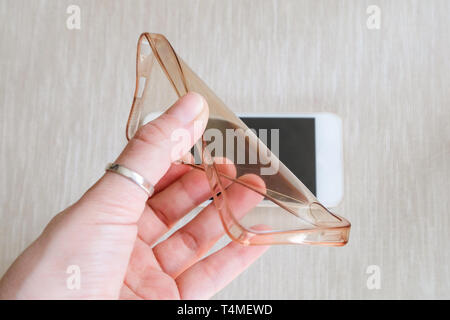 Silicone case for smartphone bent in his hand Stock Photo