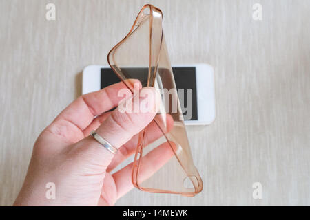 Silicone case for smartphone bent in his hand Stock Photo